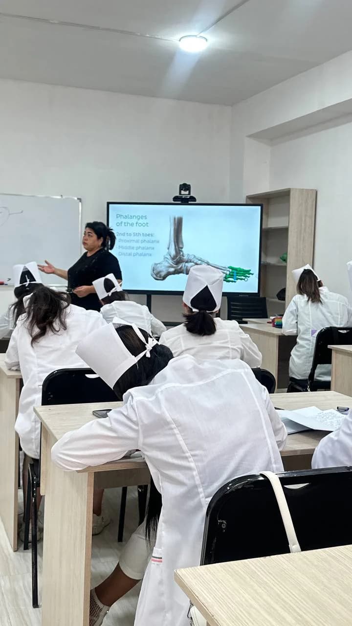 Students attending a lecture with a slide presentation