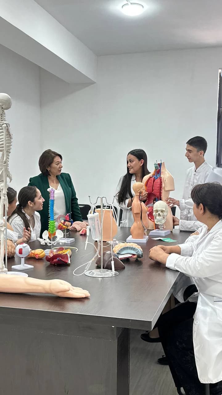 A teacher leading a class with anatomical models